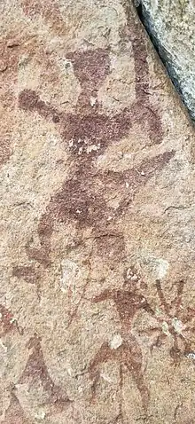 Triangular headed man with a sword