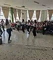 Students dancing patriotic and traditional songs songs are a typical part of the celebration of the Greek War of Independence at Greek schools.