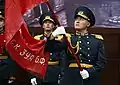 An honour guard holding the Banner of Victory.