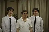 Chulalongkorn students wearing male university uniforms with former Prime Minister Abhisit Vejjajiva.