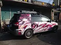 An itasha in Taiwan with Reimu Hakurei from Touhou Project on a Mitsubishi Savrin