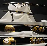 Black lacquered hanamaru mon maki-e raden daishō koshirae. Meiji period.