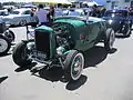 Hi-boy Deuce roadster with flatty (with factory head and exhaust but aftermarket alternator ignition and dual-carb intake), dropped tube axle, and drum brakes.