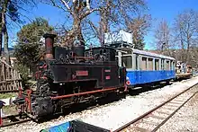 Cail narrow gauge (750 mm) steam locomotive ΔΚ-8001 and observation car ΑΒ ΔΚ-121 of the Diakofto-Kalavryta rack railway .