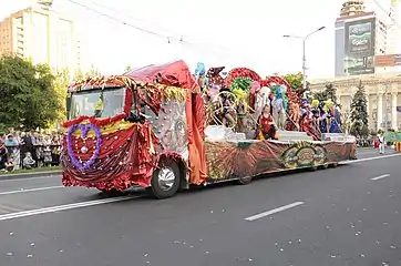 A flatbed truck being used as a parade float