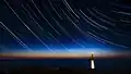 Circumpolar stars in star trails at the La Hague lighthouse, France.