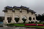 White gate with blue roof and five arches