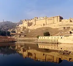 Amber Fort as seen from the bank of Maotha Lake, Jaigarh Fort on the hills in the background