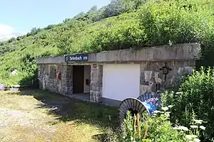 One-story stone entrance protruding from mountain