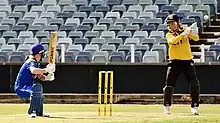 ACT Women captain Katie Mack plays a paddle scoop shot against WA Women during a WNCL match at the WACA Ground in Perth. The wicket-keeper is Beth Mooney