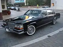 Wire hubcaps mimicking real wire wheels on a 1989 Cadillac Brougham