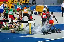 2009 World steeplechase runners with numbers on the back of bibs