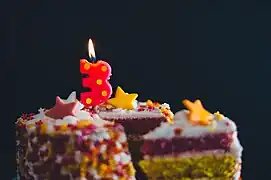 Birthday cake with a "3" shaped candle