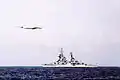 A Tu-95 Bear overflies a Sverdlov-class cruiser 1975