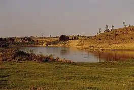 A small lake, with sandy banks