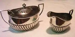 A creamer and sugar bowl used by the Atchison, Topeka and Santa Fe Railway, made by Harrison & Howson for dining car service