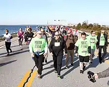 Larry Hogan and his team move across the bridge as others run behind them