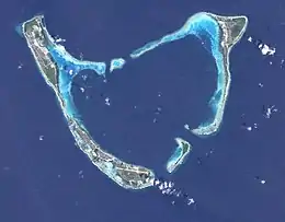 Addu Atoll seen from space. Gan lies at the end of the continuous reef fringing Addu from the west and southwest