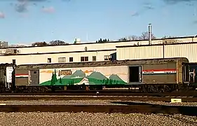 A railway baggage car painted with a mural of mountains