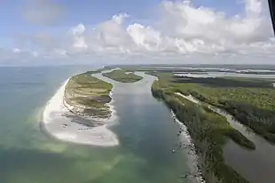 Aerial view of a barrier peninsula sheltering an inlet