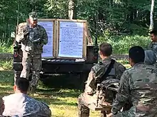 1-337th BSB Observer/Controller-Trainer conducts an After-action review at Camp Ripley during CSTX 86-17-03