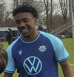 Akeem García smiling as he meets young fans at the stadium