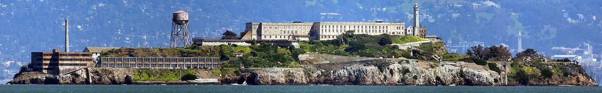 A panorama of Alcatraz as viewed from San Francisco Bay, facing east. Sather Tower and UC Berkeley are visible in the background on the right. (Drag image left and right to show full panorama.)