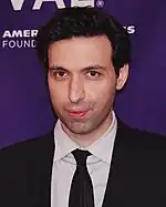 Alex Karpovsky wearing a suit and tie