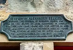 Bronze plaque in memory of Selkirk affixed to a building