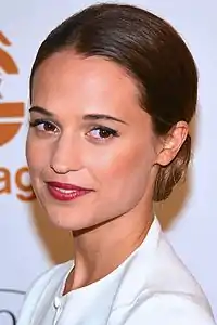 A brown haired woman looking at the camera.