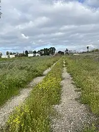 Venice–Inglewood line at the Alla wye; the Redondo Beach via Playa del Rey berm is behind the fence on the left