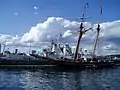 Sackville, Halifax Harbour, 1 July 2007, alongside a 2-masted sailing ship. A green maple leaf badge is visible on the ship's funnel, a common insignia of Royal Canadian Navy during World War II.