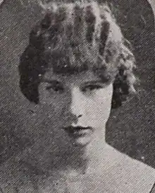 A young white woman with hair in marcelled waves