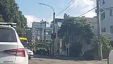 the street with cars and about three ambulances parked up