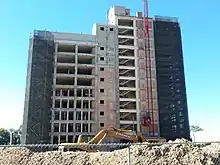 The Ziock building under renovations, with scaffolding and construction on the side of the building.