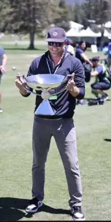 Andrew Wantuck holding the Fed Ex trophy at the 2023 American Century Championship in Lake Tahoe.