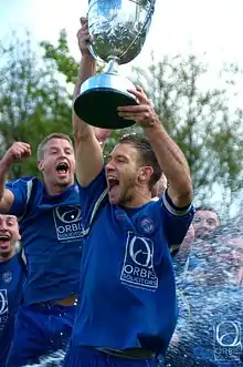 Team Captain Andy Dawson lifts the league trophy at the end of season 2011–12.