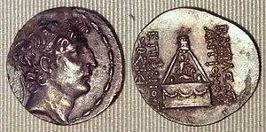 Coin of Antiochus VIII Grypus. Reverse: god Sandas standing on the horned lion, in his pyre surmounted by an eagle.