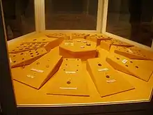 A showcase with a number of coins arranged in a circle.