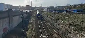 Train on the Edinburgh to Aberdeen line, with East Dock Street running parallel