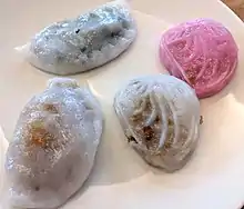 A selection of Teochew-style kueh.  Clockwise from top left, two png kueh in pink and white, soon kueh and ku chai kueh.