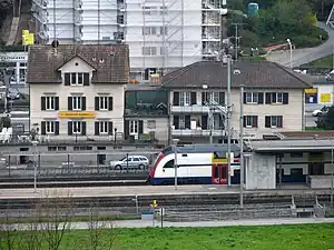 White train at island platform