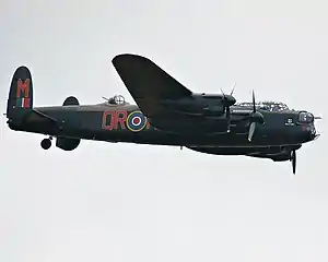 Colour photograph of a Lancaster Bomber in flight