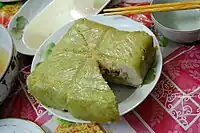 An unwrapped bánh chưng, cut into 8 pieces, ready to serve