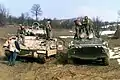 An American M2 Bradley and a Russian BTR-80 during a patrol near Zvornik