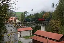 Train passing in front of the mill.