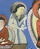 Devotee in caftan, next to the Buddha. Bamiyan (detail)