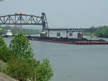 Image 13A barge hauling coal in the Louisville and Portland Canal, the only manmade section of the Ohio River (from Transportation in Kentucky)