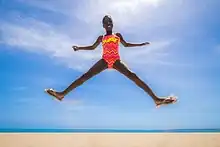 Girl wearing a pink and orange swimsuit