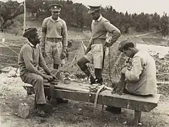 Bermuda Militia Infantry soldiers in camp, two with field service caps, circa 1940